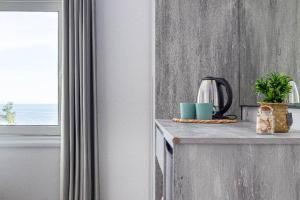 a kitchen with a counter top and a window at Hi'Mare TOP Sea View 1 - Parking and Kitchen in Himare +10 photos