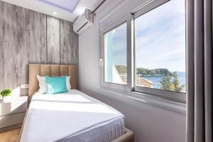 a bedroom with a bed and a large window at Hi'Mare TOP Sea View 1 - Parking and Kitchen in Himare