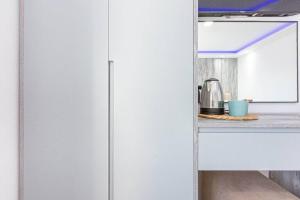 a kitchen with a refrigerator and a coffee maker on a counter at Hi'Mare TOP Sea View 1 - Parking and Kitchen in Himare