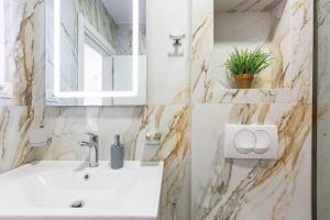 a bathroom with a sink and a mirror at Hi'Mare TOP Sea View 1 - Parking and Kitchen in Himare