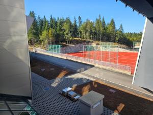 a view of a tennis court from the window of a building at Mountain goat Bjelašnica in Bjelašnica