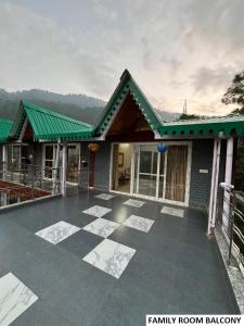 a house with a large patio in front of it at Odyssey Stays Bhimtal in Bhīm Tāl +23 photos