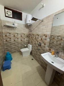 a bathroom with a sink and a toilet at Odyssey Stays Bhimtal in Bhīm Tāl