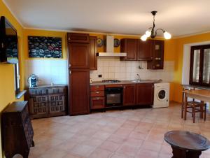 a kitchen with wooden cabinets and a stove top oven at La vigna in Costigliole dʼAsti