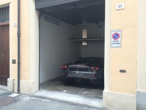 a car is parked inside of a garage at Callegherie 21 Boutique B&B in Imola