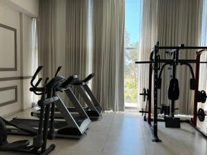 a gym with several tread machines in front of a window at Prince Palace Netanya Lagoon Beach 3BR in Netanya