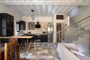 a kitchen with a table and a refrigerator in a room at Kavos House in Meyisti +24 photos