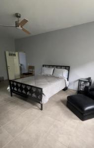 a bedroom with a bed and a chair at Villa Vicente Casa Soares in Vila Nova Sintra