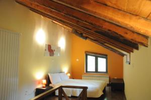 a bedroom with a bed and a table and a window at Giusvalla Forest Village in Dego