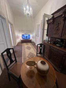 a living room with a table and a television at Csaky palace 2 Bratislava in Bratislava