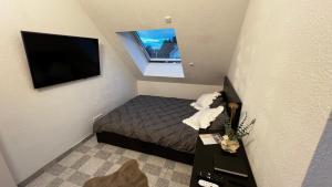 Μια τηλεόραση ή/και κέντρο ψυχαγωγίας στο Modernes Apartment in Nähe des Ravensburger Zentrums und Bodensee