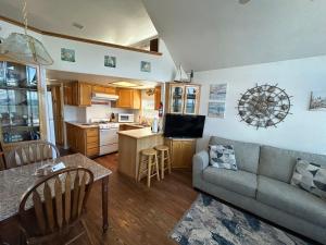 a living room with a couch and a kitchen at Oceanfront Cabin 9 With Jacuzzi & Awesome Views in Smith River