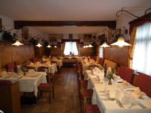 a dining room with white tables and chairs and lights at B&B Leonardi in Monclassico