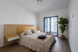 a bedroom with a large bed and a window at Modern condo Praia da Rocha,Terracos Da Ciudade in Portimão +24 photos
