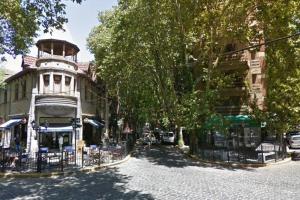 a street with a building with a tower on it at Beautiful apartment in the heart of Vicente López in Olivos