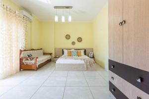 a bedroom with a bed and a couch at Stella's Central - 1min beach, kitchen & balcony in Himare