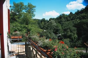 a balcony with a bunch of flowers and trees at Al Moin Beds & Homes in San Zuanet