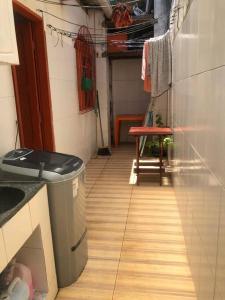 a small kitchen with a trash can and a table at Casa beiramar sitio do conde in Conde +8 photos
