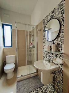 a bathroom with a toilet and a sink and a shower at TheStay Gozo in Mġarr