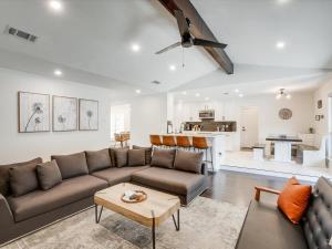 a living room with a couch and a table at Modern Luxury Home Pool Oasis & Backyard Retreat in Plano