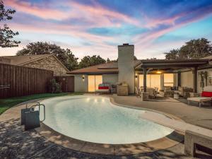 a swimming pool in the backyard of a house at Modern Luxury Home Pool Oasis & Backyard Retreat in Plano