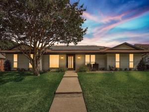 a house with a tree in the yard at Modern Luxury Home Pool Oasis & Backyard Retreat in Plano