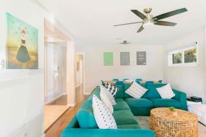 a living room with a blue couch and a ceiling fan at Spacious Luxurious House Big Groups and Pool in Irving