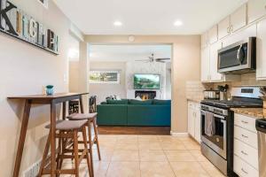 a kitchen and living room with a green couch at Spacious Luxurious House Big Groups and Pool in Irving +34 photos