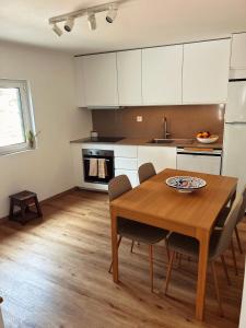 cocina con mesa de madera y sillas en Casa do Beco, en Moninho