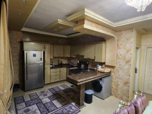 a large kitchen with a counter and a refrigerator at Luxury 2BH with full Cairo Nile view in Cairo