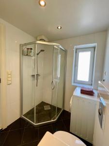 a bathroom with a shower and a toilet and a window at Harmony Home in Stavanger +19 photos