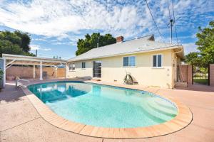 a large swimming pool in front of a house at Valley Ranch With Pool in Los Angeles