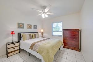 a bedroom with a bed and a ceiling fan at Golf, Swim, Relax Rotonda West Home with Pool in Rotonda West +34 photos