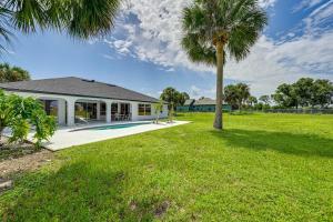 a house with a palm tree in the yard at Golf, Swim, Relax Rotonda West Home with Pool in Rotonda West