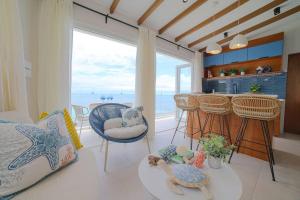 a living room with a kitchen with a view of the ocean at DelMare At Buye Beach Rooftop in El Cerro