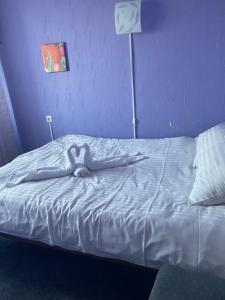 a woman laying on a bed with her hands on her face at Campsite Jelgava in Jelgava