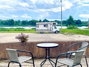 a table and two chairs and a table and a trailer at Campsite Jelgava in Jelgava