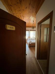 a room with a bedroom with a bed and a door at Amalia's House in Gjirokastër