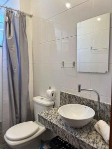 een badkamer met een wastafel, een toilet en een spiegel bij LK Lourdes 6 in Belo Horizonte