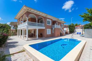 a villa with a swimming pool in front of a house at Villa SunShine Ciudad Quesada Spain in Ciudad Quesada