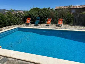 a group of chairs and a swimming pool at Le Clos de l’Olivier in Aubenas