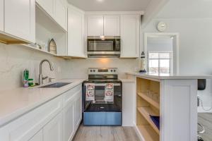 a white kitchen with a stove and a microwave at End Unit with Clear Lake Access in NorCal! in Clearlake