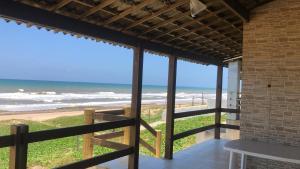 a balcony with a view of the beach at Casa beiramar sitio do conde in Conde