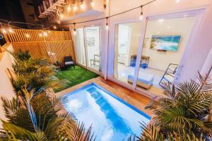 una piscina en medio de una habitación con plantas en Special apartment with pool in Noord Aruba, en Palm-Eagle Beach 3 fotos más