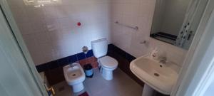 a small bathroom with a toilet and a sink at Jolie Villa vue montagne et piscine privée in Tangier +14 photos