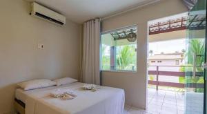 Ένα ή περισσότερα κρεβάτια σε δωμάτιο στο Casa espaçosa no Prive Baia do Cupe +24 φωτογραφίες