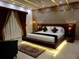 a bedroom with a bed and a large window at Royal Galaxy Hotel & Residence - Near Islamabad International Airport & Motorway in Islamabad