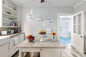 a kitchen with a counter with a cake on a table at Ms. Bunny's Bungalow in Fredericksburg