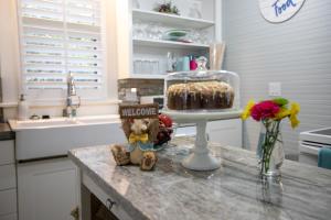a kitchen counter with a cake on a table at Ms. Bunny's Bungalow in Fredericksburg