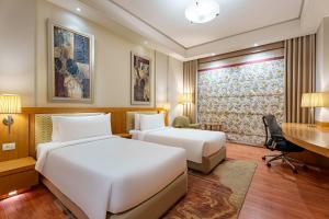 Postel nebo postele na pokoji v ubytování Radisson Noida